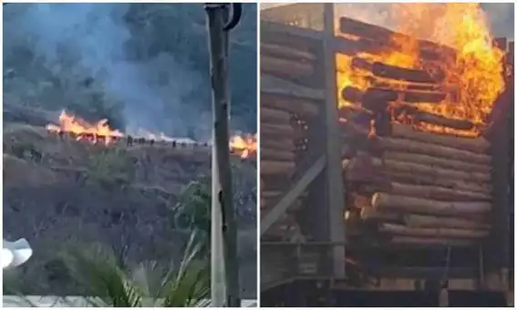 Vagões de trem em chamas, com equipes de bombeiros trabalhando no combate ao incêndio, em meio à vegetação de Minas Gerais